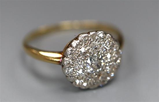 A mid 20th century yellow metal and circular diamond cluster ring, size Q, gross 2.1 grams.